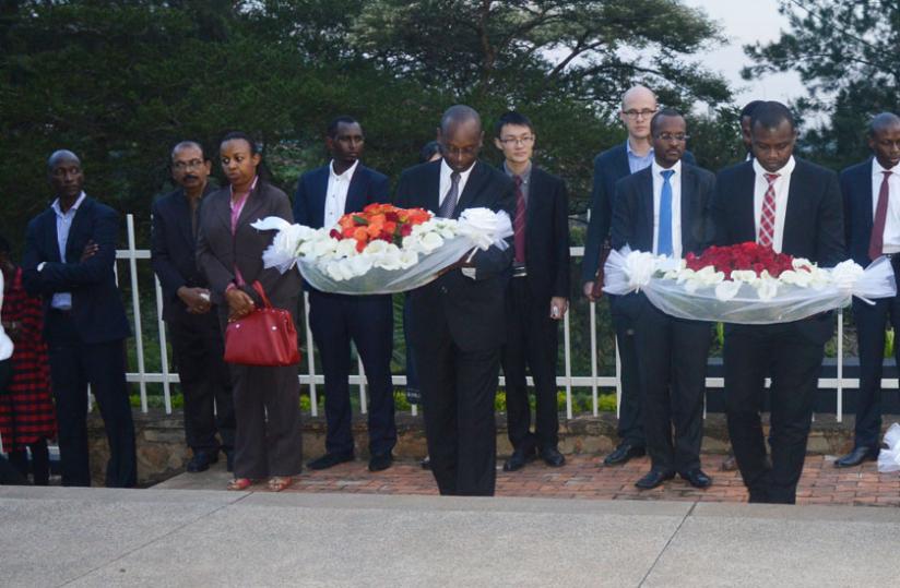 Dr Gasanabo (L) and  Mutanguha lay wreaths on mass graves at Kigali Genocide Memorial site during the international genocide commemoration event, on Wednesday. (Jean d'Amour Mugabo)