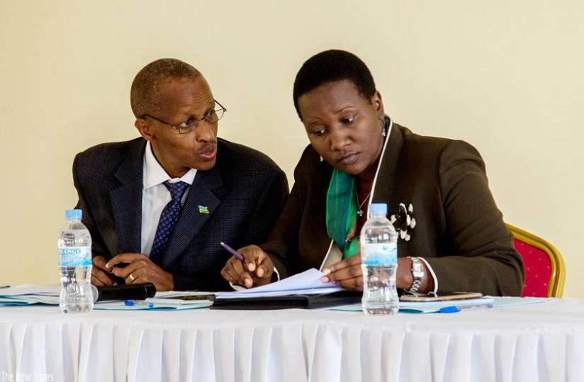 Deo Nkusi, the executive secretary of the Chancellery for Heroes, National Orders and Decoration of Honours (L), speaks to Sports and Culture minister Julienne Uwacu during a meeting with living heroes on sustainability and dispersal of heroism in Kigali yesterday. (Doreen Umutesi)