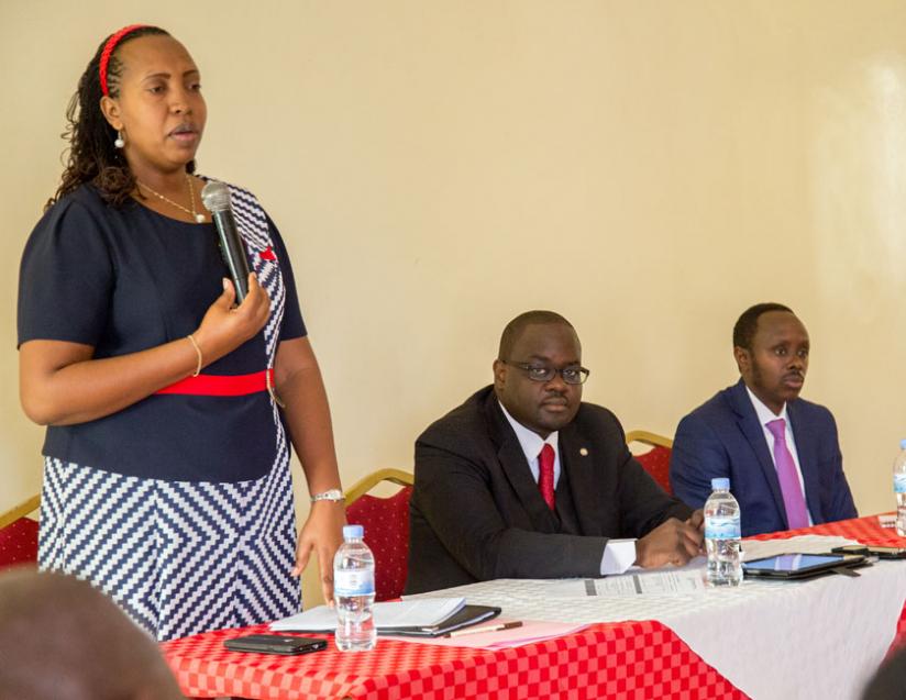 Odette Yankurije, Head of Access to Justice Services department at the Ministry of Justice speaks to lawyers while opening up a three day training on legal representation of children during trial. Looking on is Julien Kavaruganda, the president of the Rwanda Bar Association and Andrews Kananga the Executive Director of Legal Aid Forum. (Doreen Umutesi)