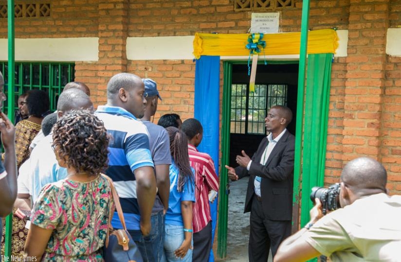 A polling assistant explains instructions to voters at Remera Catholic Primary School last week. (File)