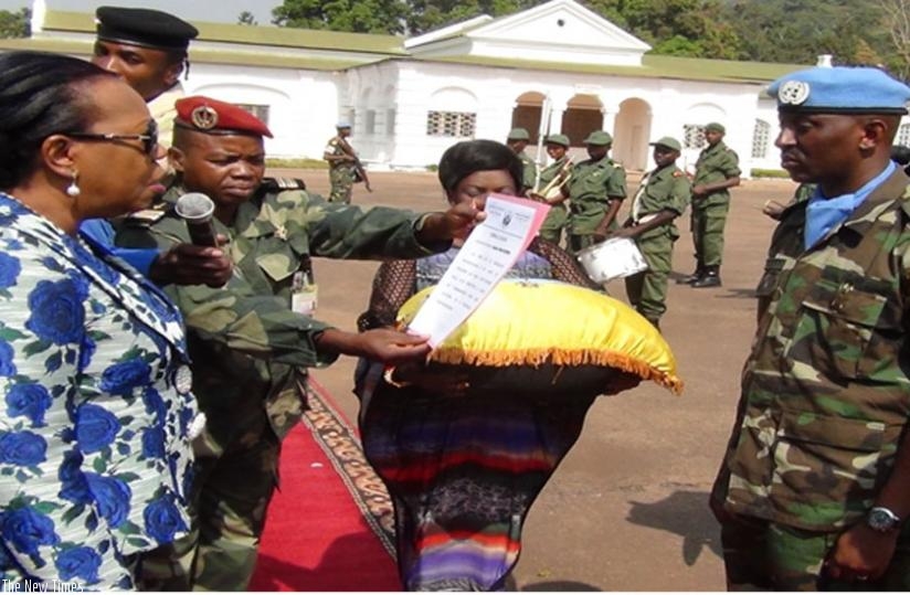 President Samba-Panza (L) bestows an award on Lt Col Ndayizeye in Bangui. Rwandan peacekeepers were decorated for their professionalism and contribution to peace and stability of CAR. (Courtesy)