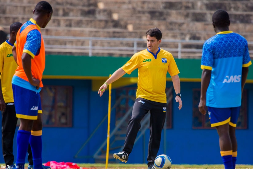 Amavubi coach Johnny Mckinstry takes players through training drills recently. (File)