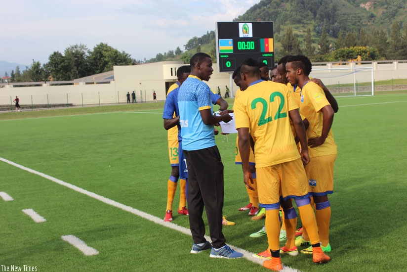 Amavubi assistant coah Jimmy Mulisa talking to players during Wednesday's friendly match against Cameroon that ended 1-1. (Sam Ngendahimana)