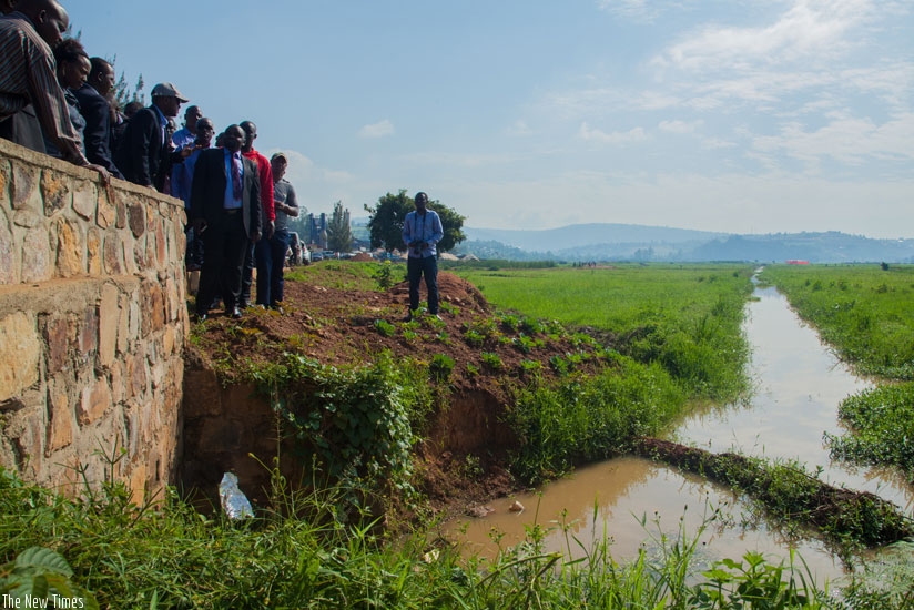 Nsanganira (with a cap) and local officials visit Nyagisenyi marshland last week. (Photos by Faustin Niyigena)