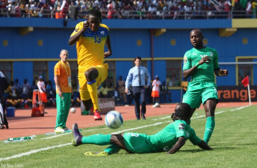 Amavubi right-back Fitina Ombalenga manoeuvres a challenge from an  Ivorian  defender in the opening match of CHAN at Amahoro Stadium on Saturday. (S. Ngendahimana)