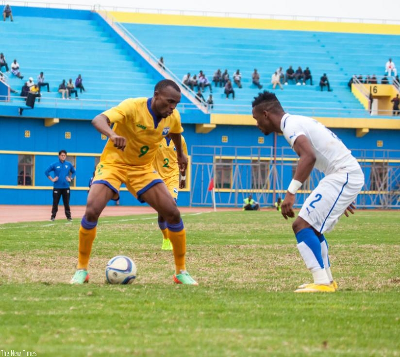 Amavubi skipper Jacques Tuyisenge tries to dribble past a Gabonese defender during a friendly game last year. Gabon won 1-0. (Timothy Kisambira)