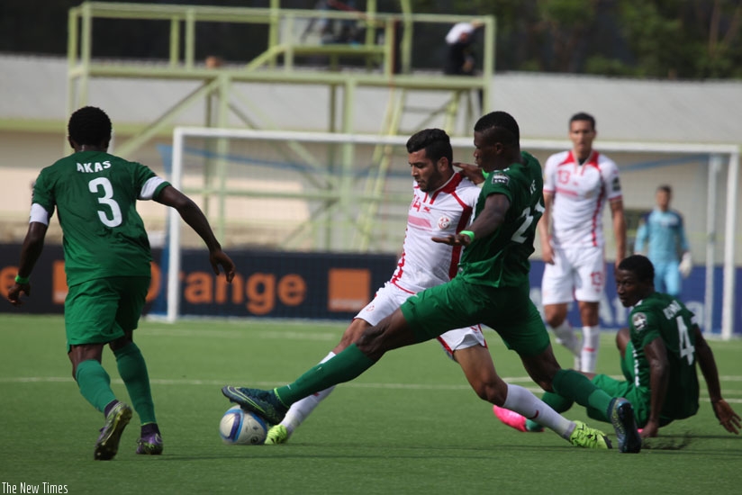 Tunisia midfielder Muhamed Ben Amor battles with Nigeria defender Stephen Eze at Kigali Regional Stadium yesterday. (Sam Ngendahimana)