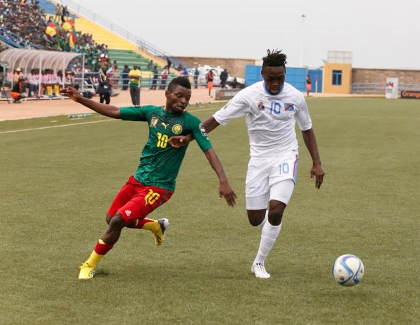 Cameroon's Yazid Atouba vies for the ball against DR Congo's Franck Mfuki during the final Group A match at Huye stadium. (Courtesy)