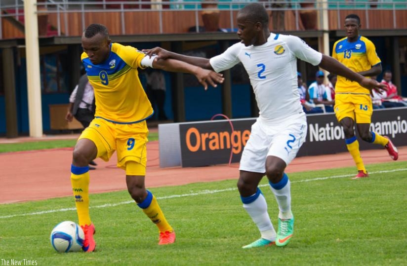 Rwanda CHAN team captain Jacques Tuyisenge (L) takes on Gabonese defender Georges Ambouroute last week. (Timothy Kisambira)