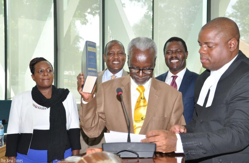 Kivenjija takes the Oath of Allegiance assisted by Clerk Assistant, Victor Manzi, as EALA Members, from left, Dora Byamukama, AbuBakr Ogle and Bernard Mulengani look on. (Courtesy)