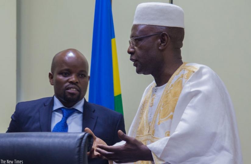 Minister Nsengimana (L) chats with Deputy Speaker Mukama Abbas yesterday at Parliament. (Faustin Niyigena)