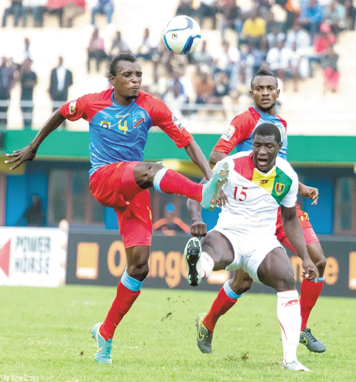 DRC defender Padou Bompunga (L) controls the ball against Guinea's Alseny Agogo.  The defender was booked and will miss the final game on Sunday. (T. Kisambira)