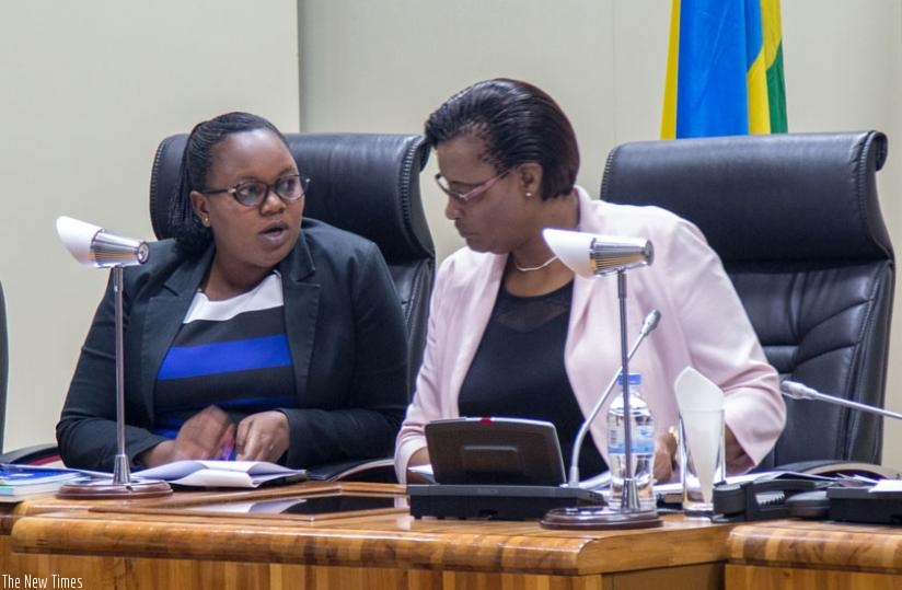 The Deputy Speaker of Parliament in charge of Legislation, Jeanne d'Arc Uwimanimpaye (L) and Speaker Donatille Mukabalisa consult during the session to approve the Maternity Leave Benefits Scheme yesterday. (Doreen Umutesi)