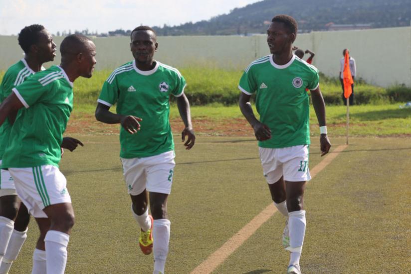 Andre Lomami (right) celebrating his third goal with teammates at Mumena stadium (Richard Bishumba)