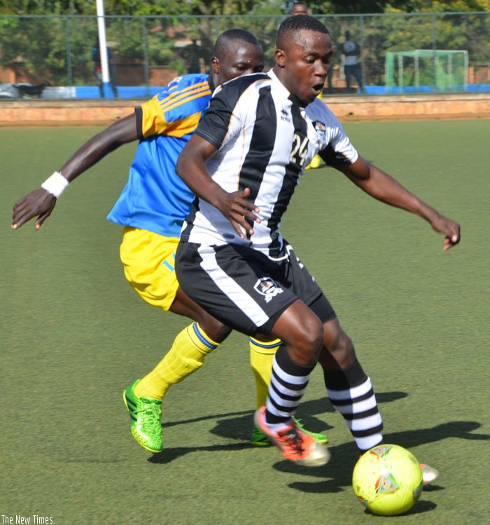 APR striker Michel Ndahinduka is kept in check by Amagaju's Didier Nkurunziza during the league match last season, a game APR won 2-0. (Sam Ngendahimana)