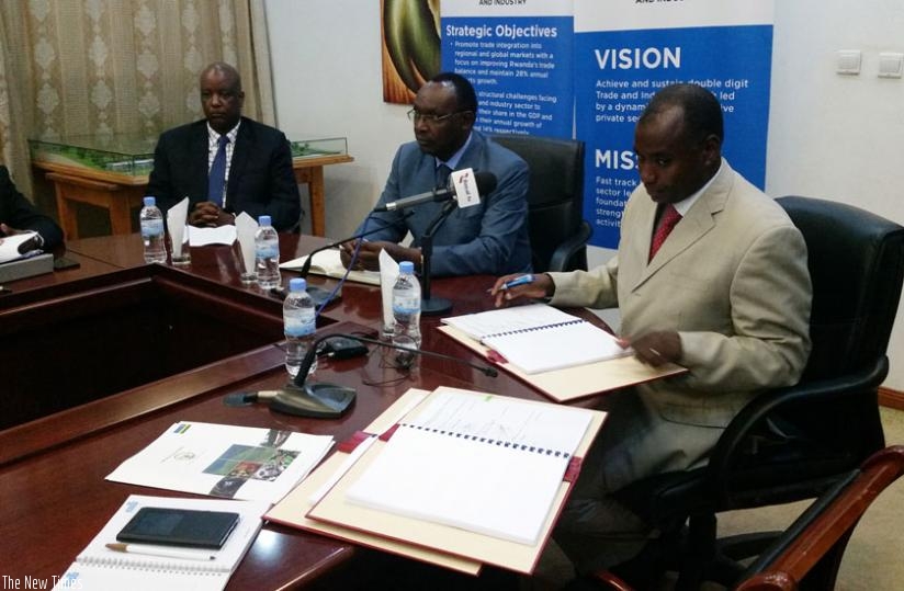 Lu2013R: Mark Nkurunziza, the Rwanda Development Board chief finance officer, Kanimba and Semugaza at the signing of the concession agreement  in Kigali on Tuesday. (Peterson Tumwebaze)