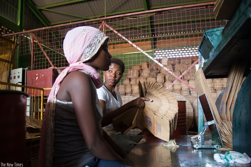 Workers of SRB Investment Rwanda Ltd pack finished paper bags at the factory. (Timothy Kisambira)