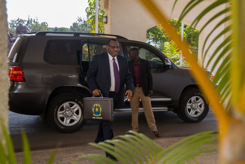 Minister Gatete arrives at Parliament to present the Budget yesterday. (Timothy Kisambira)