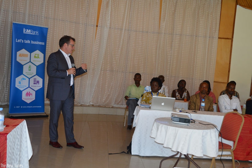 Bairstow (left) addresses some of the bank's customers in Karongi last week. (Hudson Kuteesa)