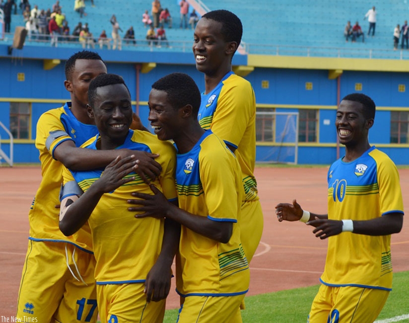 Itangishaka  (2nd left) is mobbed by his teammates after giving Rwanda the lead against Morocco on Saturday. (Courtesy)