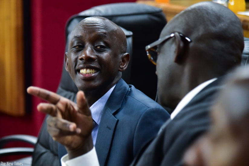 Kaboneka (L) chats with Justice minister Johnston Busingye during the meeting at Parliament yesterday. (Nadege Imbabazi)
