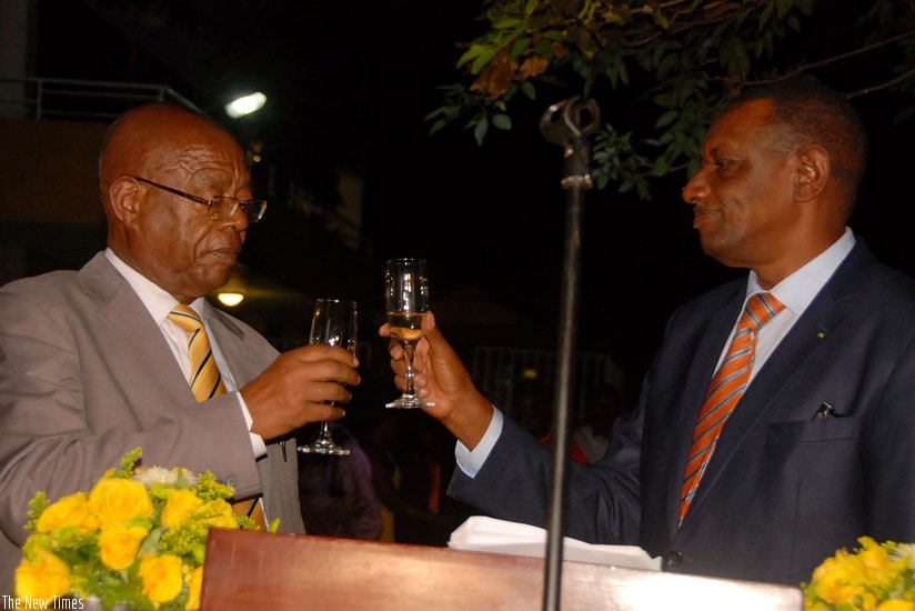 Amb. Mugambage (R) and Mateke toast during the event to mark the Liberation Day in Kampala yesterday. (Courtesy)