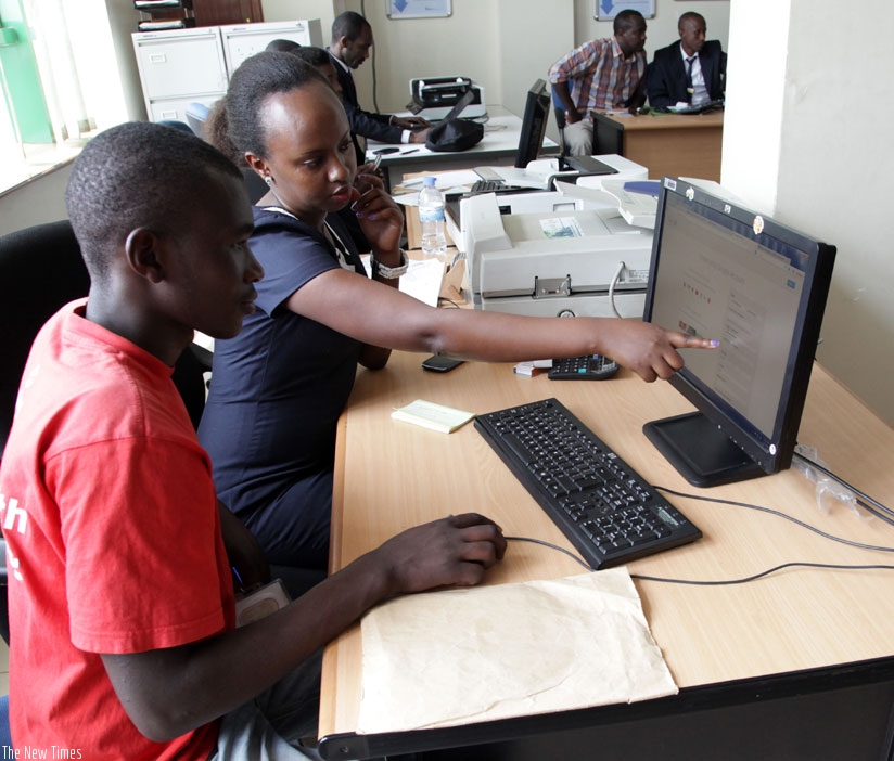 An official at RDB (R) guides a client on how to register business online. (File)