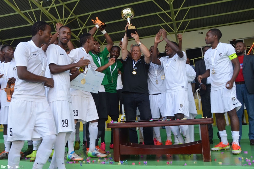 APR coach Nizar Khanfir holds the league trophy aloft on Sunday. It remains unclear whether Khanfir will stay on after this season. S. Ngendahimana