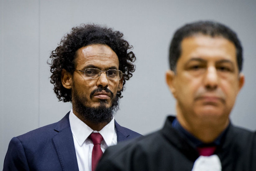 Ahmad al-Mahdi, left, appears at an earlier hearing at the international criminal court in The Hague. rnPhotograph: Robin van Lonkhuijsen/AFP/Getty Images