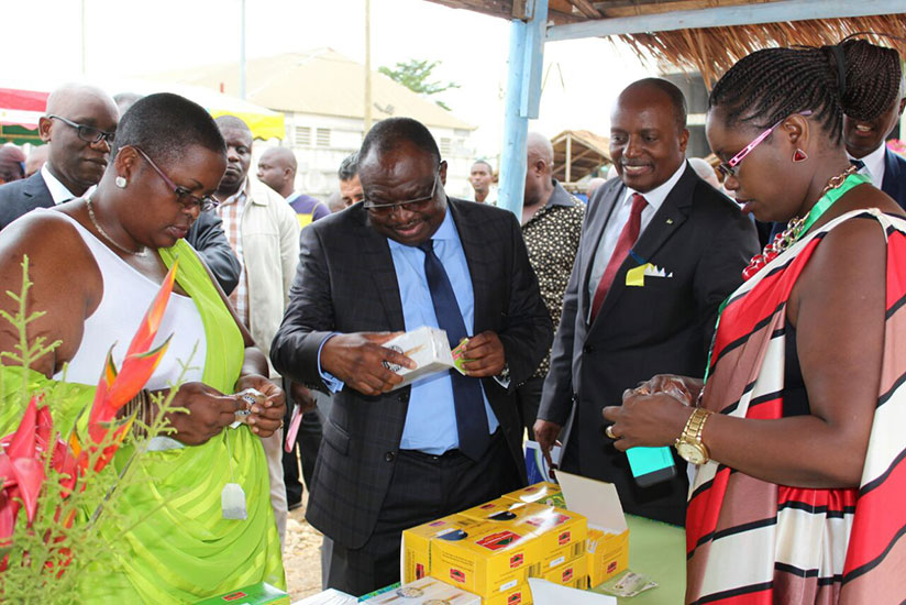 (L-R) Christine Murebwayire, chairperson Chamber of Rwandan farmers, Congolese minister Kolelas and Amb Habyarimana admire a product exhibited by one of the Rwandan exhibitors (right) last week. / Courtesy