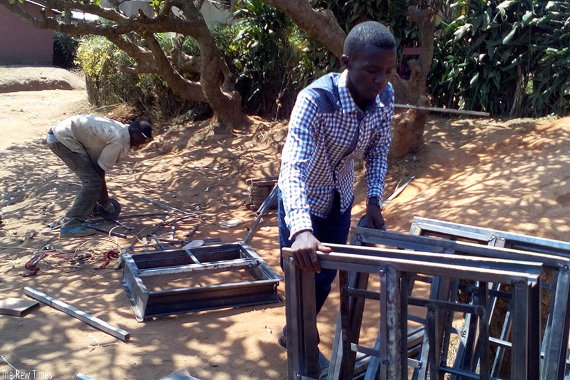 Metal fabricators assemble windows at their workshop in Kigali. Small businesses, like this one, need more support to grow and become sustainable. (File.)