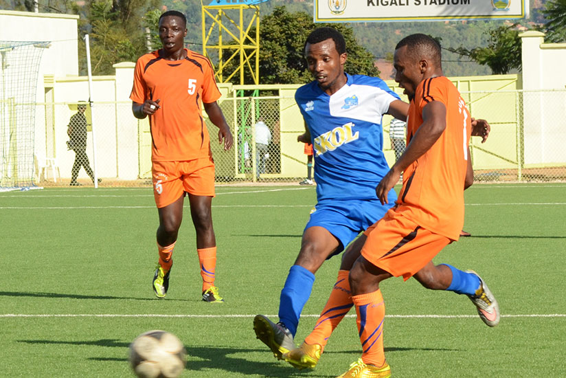 Rayon Sports' Savio Nshuti (C) tries to go past a Bugesera FC defenders in one of the team's last season's encounters at Kigali Regional Stadium. / Sam Ngendahimana