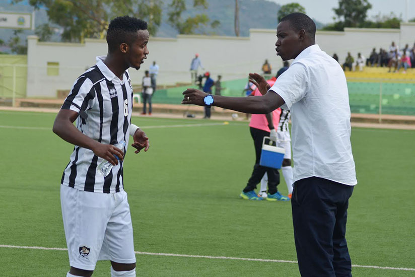 APR FC's head coach Jimmy Mulisa briefs midfielder Yannick Mukunzi at Kigali Regional Stadium last Friday. / Sam Ngendahimana