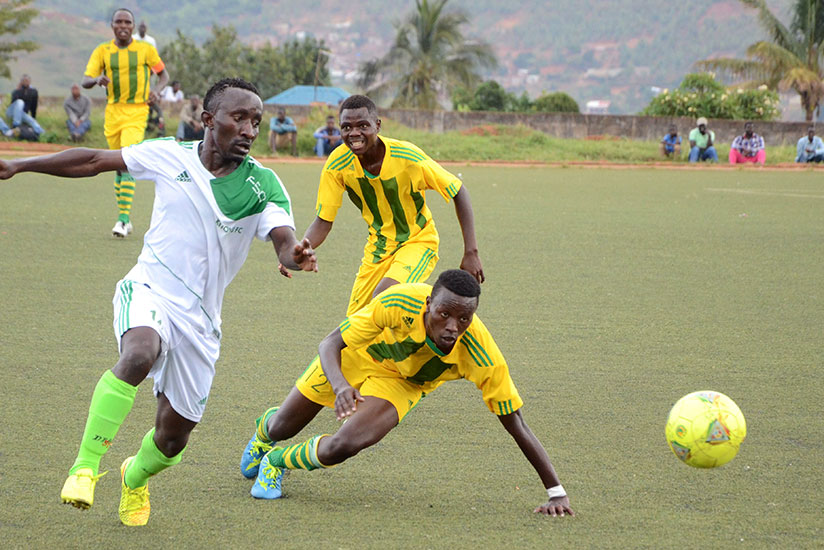 Marine FC players try to stop SC Kiyovu midfielder Jean Paul Havugarurema (left) during the two sides' tie last season at Mumena stadium. / File