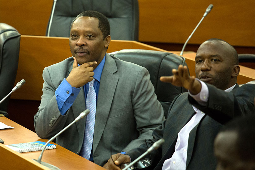 Gallican Niyongana (R), the chairperson of the senatorial Standing Committee on Social Affairs, Human Rights and Petitions makes a point as Prof. Anastase Shyaka looks on. / Timothy Kisambira