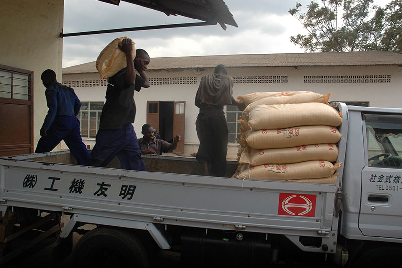 Workers at Kabuye sugar factory load sacks of  sugar on a truck. / File