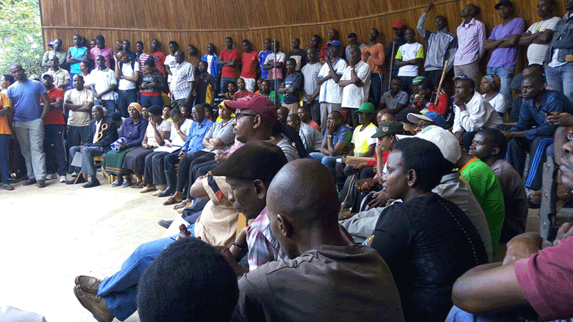 Students together with area residents at the Kigali Memorial Centre in Gisozi after the umuganda session. / Hudson Kuteesa. 