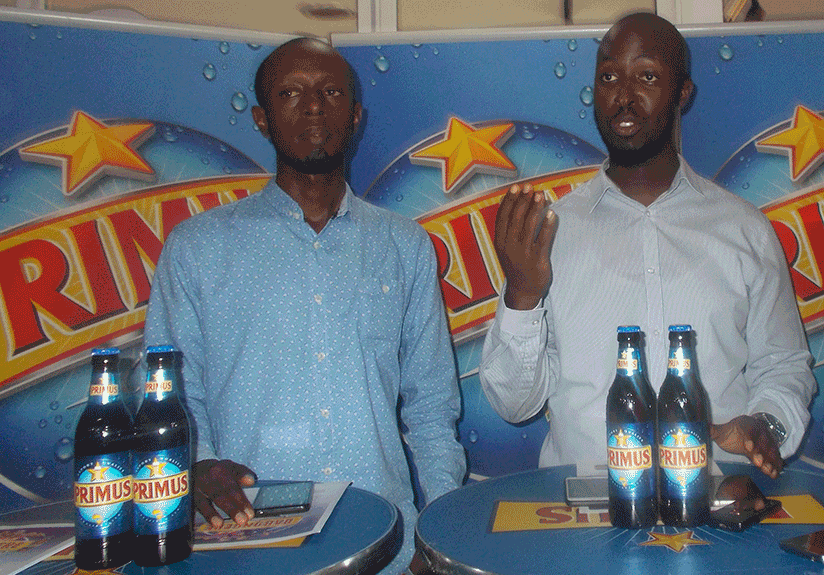 Sam Mpendo, Bralirwa Senior Brand Manager (C)addressing media on Monday about the promotion while Benjamin Havugimana, Channel manager 1st L looks on.(Elias Hakizimana)