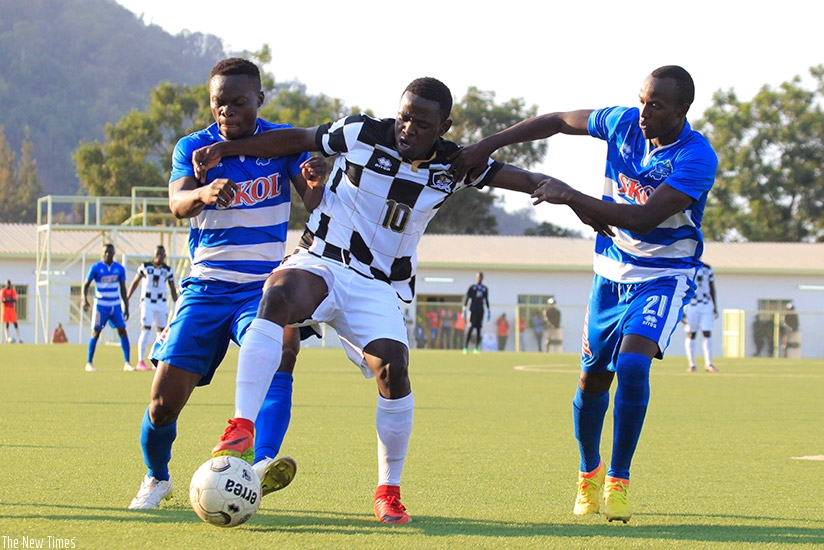 APR midifielder Muhadjiri Hakizimana (C) takes on Rayon's Pierrot Kwizera (R) and Olivier Seif Niyonzima in last season's game. Sam Ngenadahimana.