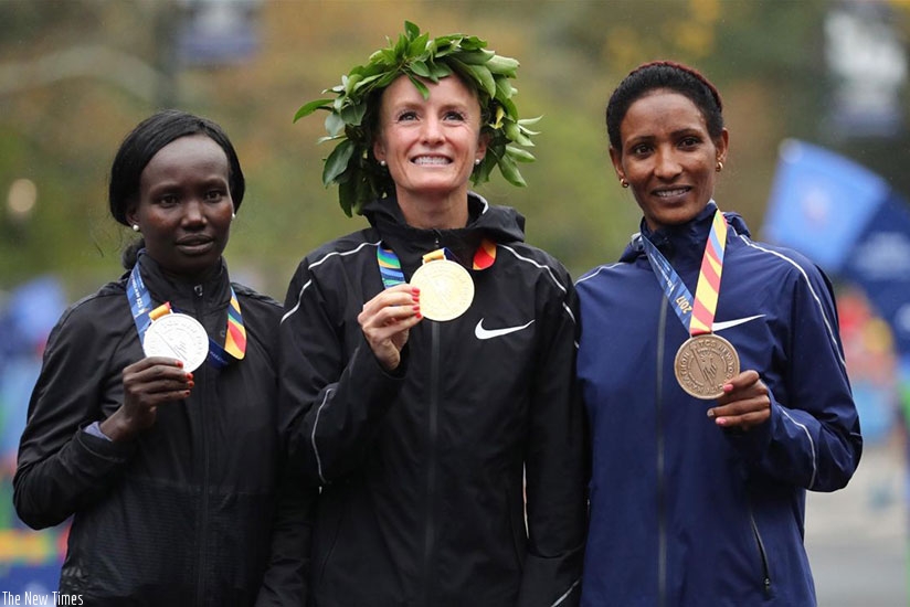 Flanagan (C) became the first American woman to win the New York City Marathon in 40 years when she claimed a dominant victory over Kenyan three-times champion Keitany (L) on Sunda....