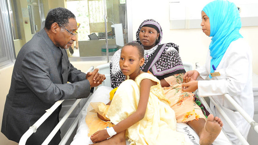 Zanzibaru2019s Minister for health and social welfare, Hamad Rashid Mohammed interacts with the patients on the island. 