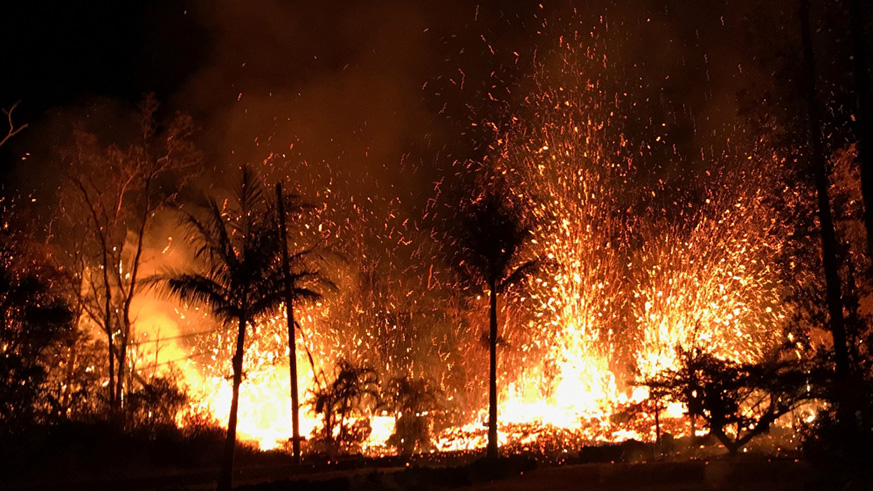 Handout photo of a new fissure spraying lava fountains as high as about 230 feet (70 metres), according to United States Geological Survey, is shown from Luana Street in Leilani Estates subdivision on Kilauea Volcano's lower East Rift Zone in Hawaii. Courtesy