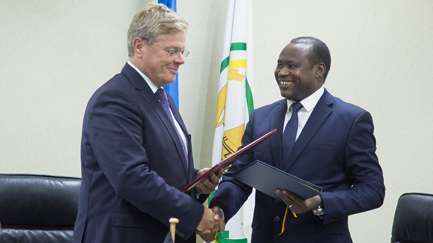  Germany  Ambassador to Rwanda, Dr. Peter Woeste and Dr. Uzziel Ndagijimana, the Minister of Finance and Economic Planning, exchange documents after signing the agreement. (Photos by Nadege Imbabazi) 