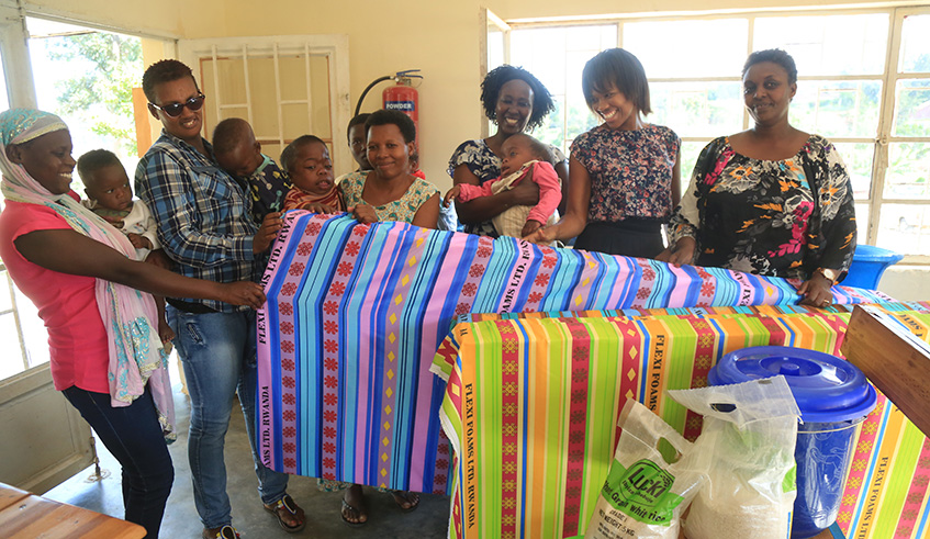 Mothers raising kids with disabilties recieve utilities at Kangondo Sector, Nyarutarama. Below (left):  Eva Gara (L) and Zuki Ngxiki, founders of Events Horizon Ltd. Below (right): Some of the mothers at Itetero School recieve utilities from Events Horizon.  Courtesy photos 