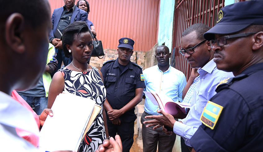 The City of Kigali Mayor, Marie-Chantal Rwakazina (left), with other officials listen to one of owners of  illegal activities in a Kigali wetland yesterday. Sam Ngendahimana.