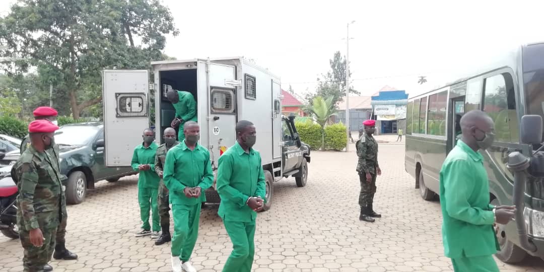 Mudathiru consults with his lawyer during the proceeding at the Military High Court. The suspects were spaced to conform to the Covid-19 measures and were all seen wearing face masks.