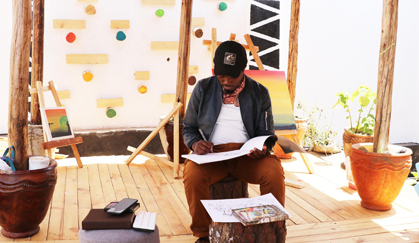 Joshua Biseruka at Sankofa Creative Limited office in Gikondo making a sketch of two women working. The illustration will be part of his Africalia funded project.