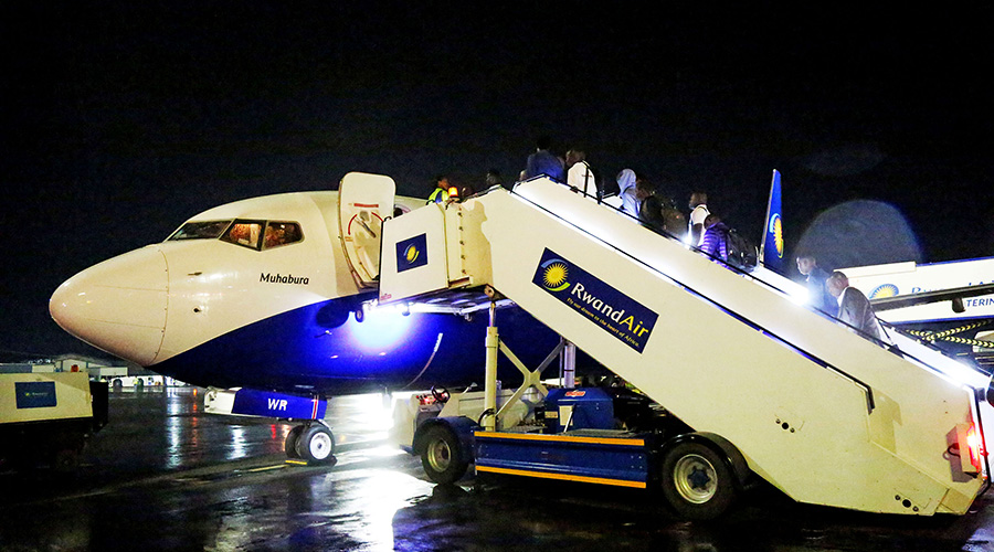 Passengers board a RwandAir plane at Kigali International Airport last year. The national carrier is expected to resume flights to Brussels, Belgium on October 3. 