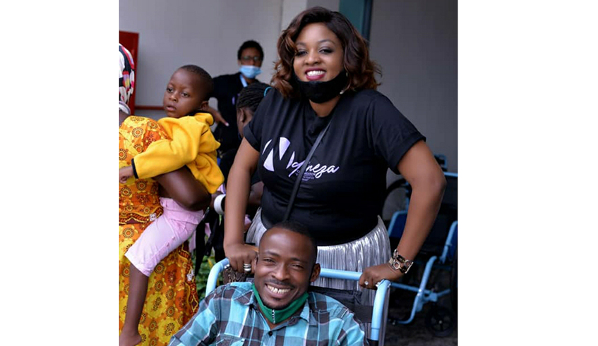 Singer Gahongayire through her charity organisation, Ndineza, donated wheelchairs to people living with disabilities . / Craish Bahizi