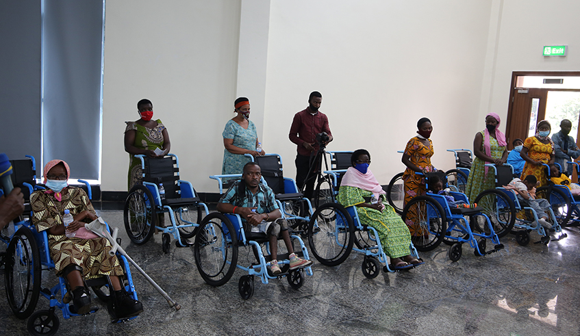 Singer Gahongayire through her charity organisation, Ndineza, donated wheelchairs to people living with disabilities . / Craish Bahizi